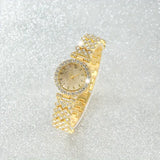 Gold watch with stone set bezel
