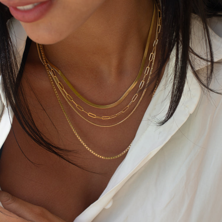 Paperclip chain necklace layered on model