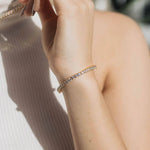 Slim tennis bracelet worn on wrist