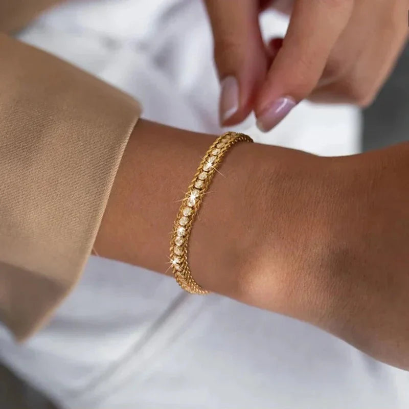 Gold tennis bracelet worn on wrist